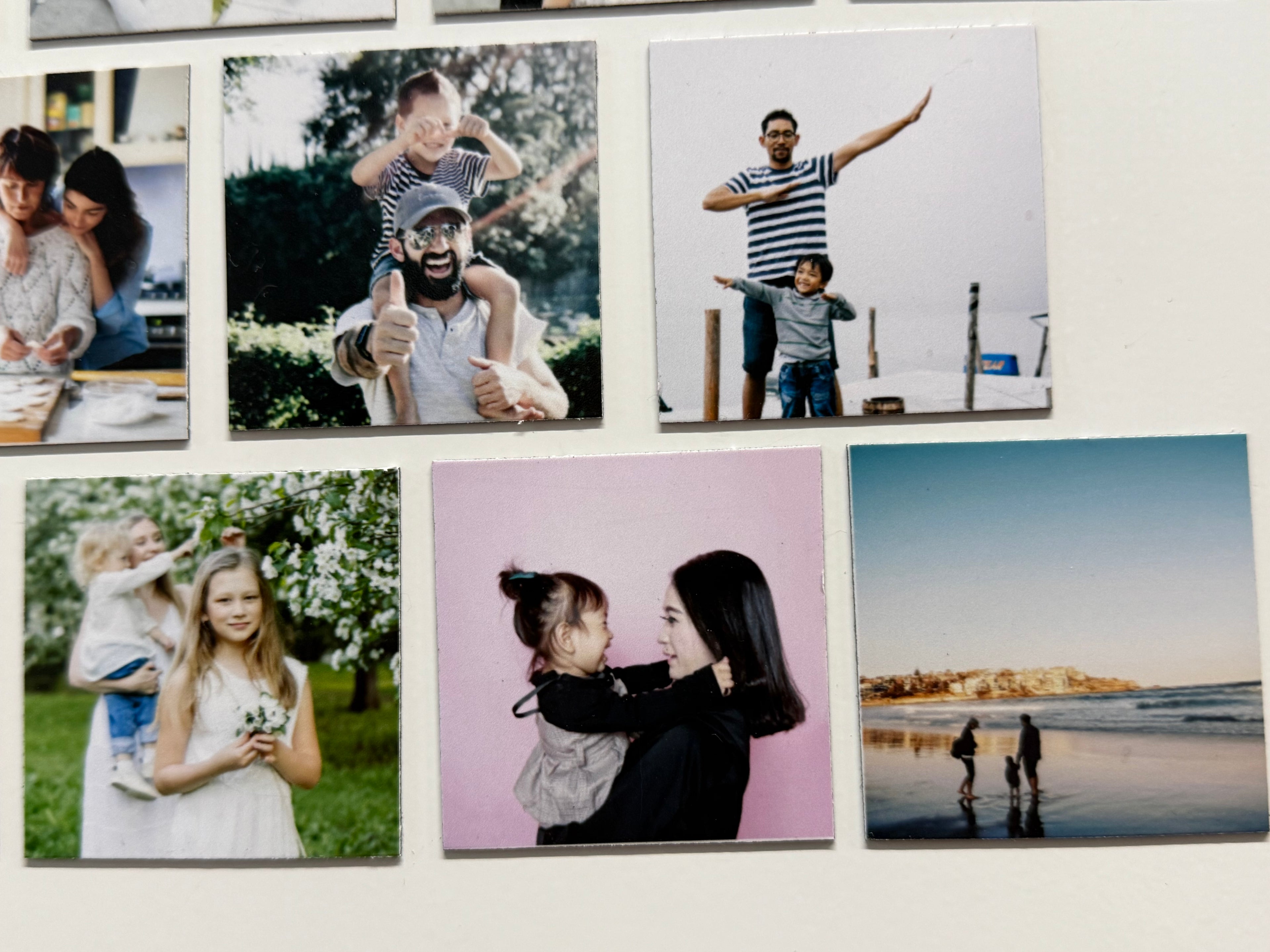 Collection of family photos displayed on a fridge